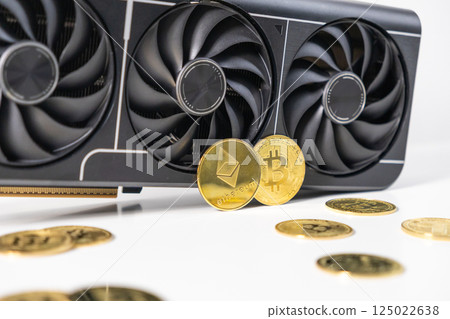 Modern GPU with triple-fan design surrounded by golden Bitcoin and Ethereum coins on white background, representing cryptocurrency mining and investment Modern GPU with triple-fan design surrounded by golden Bitcoin and Ethereum coins on white background, representing cryptocurrency mining and investment 125022638