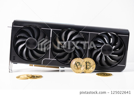 Modern black graphics card with three cooling fans and golden Bitcoin coins on white background, symbolizing GPU cryptocurrency mining hardware Modern black graphics card with three cooling fans and golden Bitcoin coins on white background, symbolizing GPU cryptocurrency mining hardware 125022641