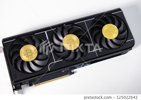 Powerful black GPU with three fans and Bitcoin coins placed on top, symbolizing cryptocurrency mining and digital blockchain technology 125022642