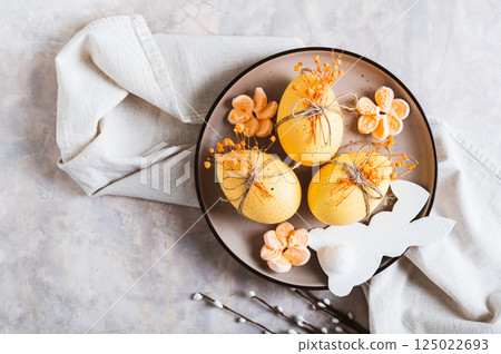 Close up of Easter decorations, decorated eggs and bunny on a plate on the table top view 125022693