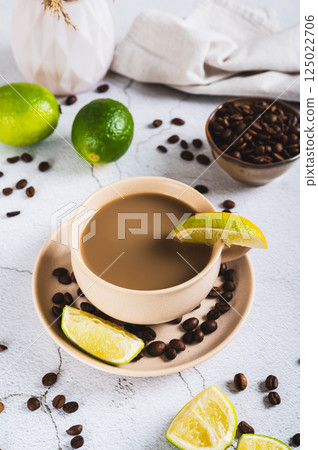 A cup of latte infused with lime on the table vertical view A cup of latte infused with lime on the table vertical view 125022706