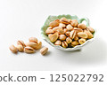 Pistachios in ceramic ware with on white background 125022792