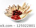 Various Chinese medicinal herbs gathered on a white ceramic plate 125022801