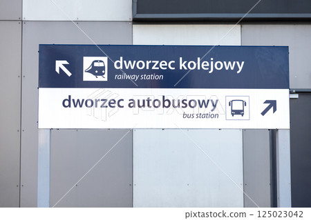 directional sign showing way to railway station and bus station with arrows and icons in polish and english language on modern grey wall background directional sign showing way to railway station and bus station with arrows and icons in polish and english language on modern grey wall background 125023042