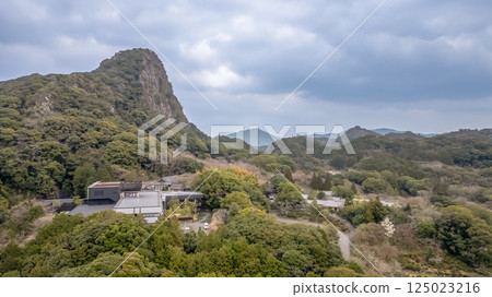 March 26 2025 Peaceful Hillside with Dense Green Forest and Architectural Building 125023216