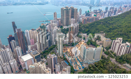 April 4 2025 Urban Hong Kong Buildings and Surrounding Green Hills, hk April 4 2025 Urban Hong Kong Buildings and Surrounding Green Hills, hk 125023253