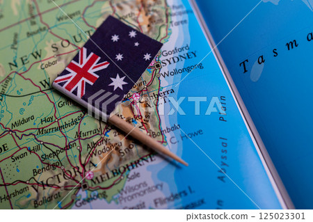A close-up of the flag of Australia on the map. The capital of Canbera. Close-up of the world map. Australia 125023301
