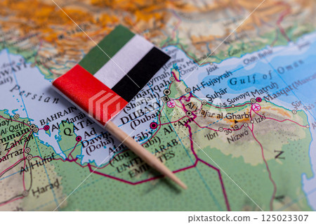 Flag of the United Arab Emirates (UAE) close-up on the map. The capital Abu Dhabi. A close-up of the world map. UAE Flag of the United Arab Emirates (UAE) close-up on the map. The capital Abu Dhabi. A close-up of the world map. UAE 125023307