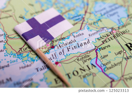Flag of Finland close-up on the map. The capital Helsinki. Close-up of the world map. Finland Flag of Finland close-up on the map. The capital Helsinki. Close-up of the world map. Finland 125023313