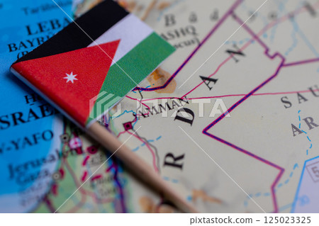 Flag of Jordan close-up on the map. The capital Amman. A close-up of the world map. Jordan 125023325