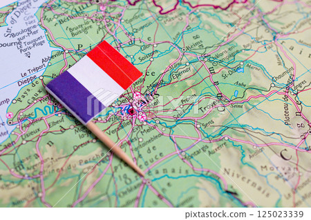 Flag of France close-up on the map near the capital Paris. A close-up of the world map. France 125023339