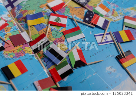 Flags of different countries are scattered on the map. Close-up of the flags. Flags of Ukraine, Lebanon, Israel, Germany, Iran and other countries Flags of different countries are scattered on the map. Close-up of the flags. Flags of Ukraine, Lebanon, Israel, Germany, Iran and other countries 125023341