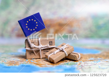 Flag of European Union near the parcels on the world map. World trade. Exports and imports of goods. Economy of the country Flag of European Union near the parcels on the world map. World trade. Exports and imports of goods. Economy of the country 125023720