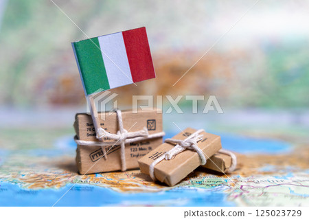 Flag of Italy near the parcels on the world map. World trade. Exports and imports of goods. Economy of the country. Flag of Italy near the parcels on the world map. World trade. Exports and imports of goods. Economy of the country. 125023729