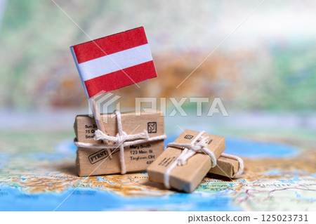 Flag of Austria near the parcels on the world map. World trade. Exports and imports of goods. Economy of the country. Flag of Austria near the parcels on the world map. World trade. Exports and imports of goods. Economy of the country. 125023731