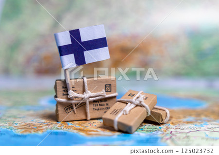 Flag of Finland near the parcels on the world map. World trade. Exports and imports of goods. Economy of the country. Flag of Finland near the parcels on the world map. World trade. Exports and imports of goods. Economy of the country. 125023732