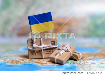 Flag of Ukraine near the parcels on the world map. World trade. Exports and imports of goods. Economy of the country. 125023734