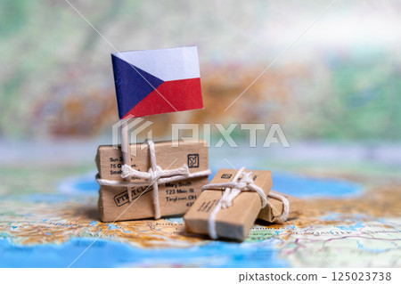 Flag of Czech Republic near the parcels on the world map. World trade. Exports and imports of goods. Economy of the country Flag of Czech Republic near the parcels on the world map. World trade. Exports and imports of goods. Economy of the country 125023738