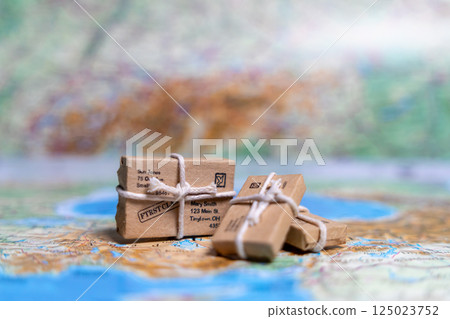 Small parcels lie on the world map. World trade, export and import of goods around the world Small parcels lie on the world map. World trade, export and import of goods around the world 125023752