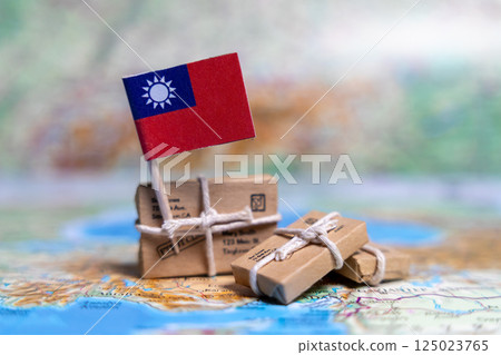 Flag of Taiwan near the parcels on the world map. World trade. Exports and imports of goods. Economy of the country 125023765