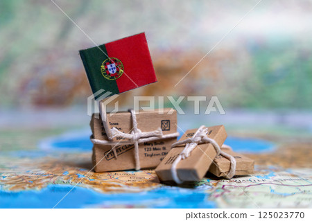 Flag of Portugal near the parcels on the world map. World trade. Exports and imports of goods. Economy of the country 125023770