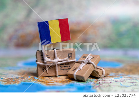 Flag of Romania near the parcels on the world map. World trade. Exports and imports of goods. Economy of the country Flag of Romania near the parcels on the world map. World trade. Exports and imports of goods. Economy of the country 125023774
