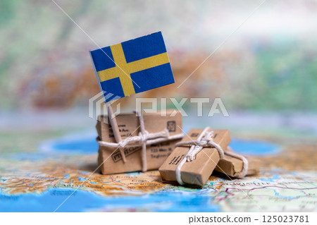 Flag of Sweden near the parcels on the world map. World trade. Exports and imports of goods. Economy of the country 125023781