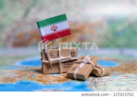 Flag of Iran near the parcels on the world map. World trade. Exports and imports of goods. Economy of the country Flag of Iran near the parcels on the world map. World trade. Exports and imports of goods. Economy of the country 125023782