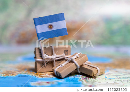 Flag of Argentina near the parcels on the world map. World trade. Exports and imports of goods. Economy of the country. 125023803