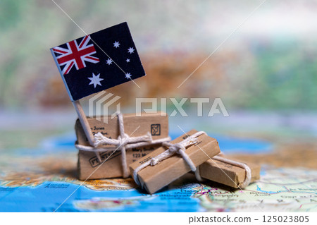 Flag of Australia near the parcels on the world map. World trade. Exports and imports of goods. Economy of the country Flag of Australia near the parcels on the world map. World trade. Exports and imports of goods. Economy of the country 125023805