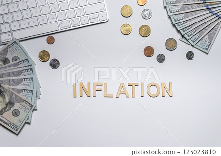 Inflation inscription among money and coins on white background top view. Crisis and financial problems in the country. Inflation inscription among money and coins on white background top view. Crisis and financial problems in the country. 125023810