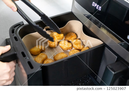 Nuggets cooked in an air fryer. Cooking in an air fryer. Nuggets cooked in an air fryer. Cooking in an air fryer. 125023907