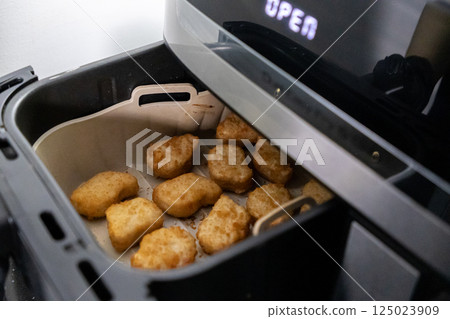 Nuggets cooked in an air fryer. Cooking in an air fryer. Nuggets cooked in an air fryer. Cooking in an air fryer. 125023909