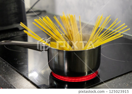 Cooking Spaghetti Pasta on a Stove. Cooking food in the kitchen 125023915