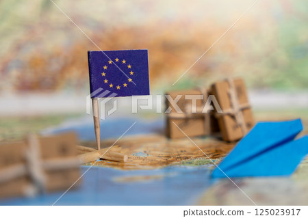 Humanitarian Aid Support from the European Union Symbolized by EU Flag and Parcels on World Map 125023917