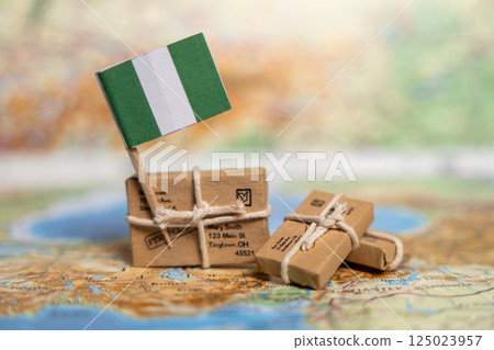 Nigeria International Shipping and Delivery Service: Small Packages with Address Labels on World Map Background with National Flag 125023957