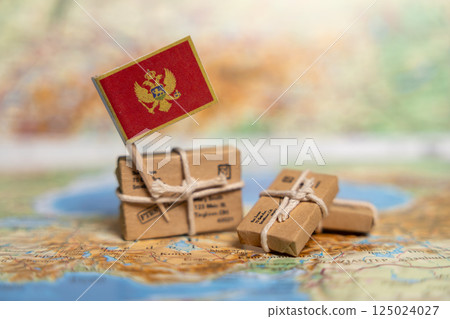 International Shipping to Montenegro: Small Parcels with Montenegrin Flag on World Map, Global Postal Delivery Services Concept 125024027