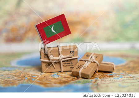 nternational Shipping to Maldives: Small Packages with Maldivian Flag on Global Map, Worldwide Postal Delivery Services Concept 125024035