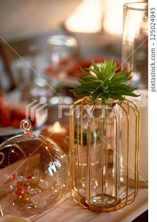 Gold candlesticks on wedding tables. Warm autumn palette. Transparent and lightweight composition 125024945