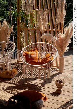 Wedding decoration. Floristics. Outdoor swing with pillows. A place for guests to relax Wedding decoration. Floristics. Outdoor swing with pillows. A place for guests to relax 125024980