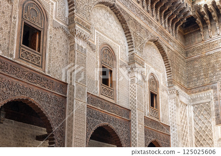 Rich decorated facade in the courtyard of the Al-Attarine Madrasa in Fes. Morocco. Rich decorated facade in the courtyard of the Al-Attarine Madrasa in Fes. Morocco. 125025606