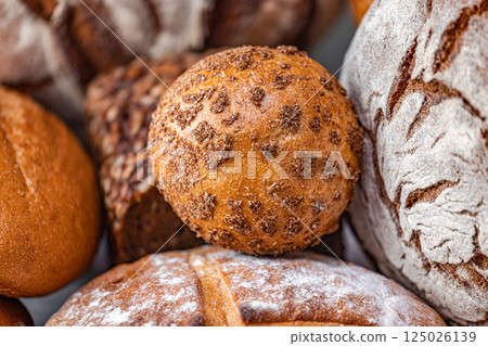 Freshly baked natural bread is on the kitchen table. Freshly baked natural bread is on the kitchen table. 125026139