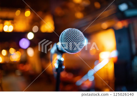 Microphone on stage against a background of auditorium. Microphone on stage against a background of auditorium. 125026140