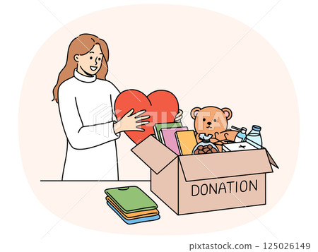 Kind woman stands near donation box with big heart in hands, wanting to help people in need Kind woman stands near donation box with big heart in hands, wanting to help people in need 125026149