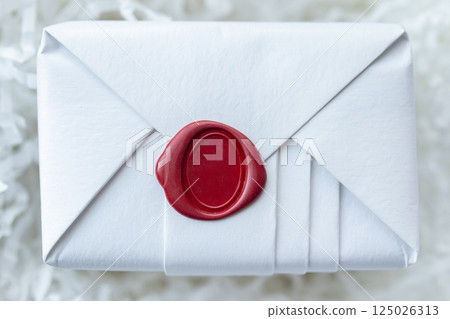 Wax seal stamp on white paper wrap packaging parcel box 125026313