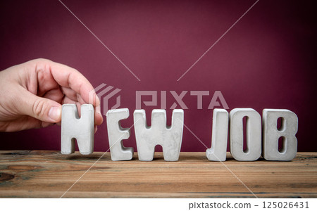 NEW JOB Word Created from Concrete Alphabet Letters on Wooden Desk 125026431