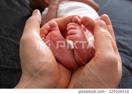 Tender Moment: Holding Newborn Baby Feet Tender Moment: Holding Newborn Baby Feet 125026518