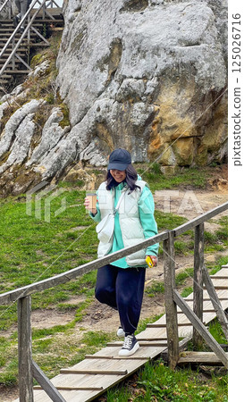 Person Walking Down Steps in Rocky Outdoor Setting Person Walking Down Steps in Rocky Outdoor Setting 125026716