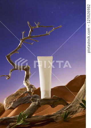 Winding branches with many cracks on the trunk, concave and convex places randomly, form a pedestal for the unlabeled tube of cream. The dry, thorny branches point straight up to the sky.  125026982