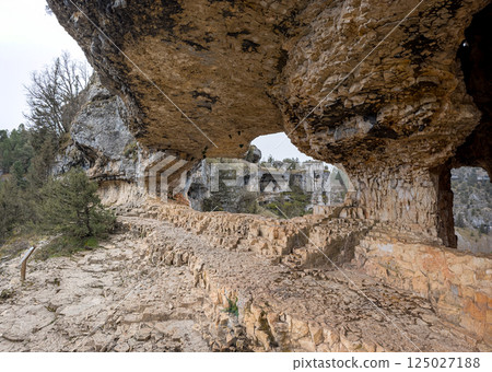 Majestic Rocky Archway with Stunning Natural Formations Majestic Rocky Archway with Stunning Natural Formations 125027188